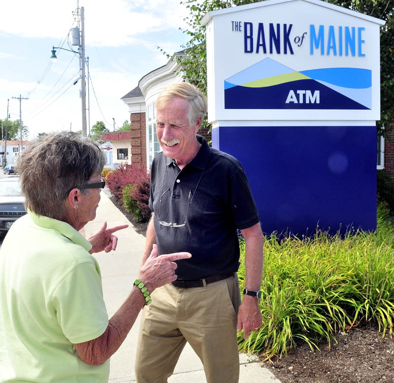 U.S. Senate candidate Angus King speaks with Penny Rafuse of Waterville on Monday during a campaign stop in Oakland. King left the Board of Directors for The Bank of Maine to allow him to campaign for U.S. Senate.