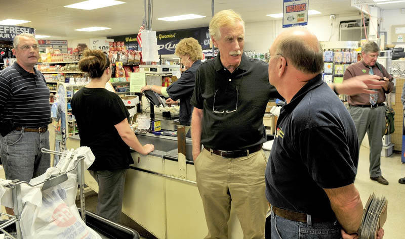 Former Maine Governor and independent candidate for U.S. Senate Angus King, center, speaks with Buddies Groceries co-owner George Rancourt on Monday during a campaign stop in Oakland.