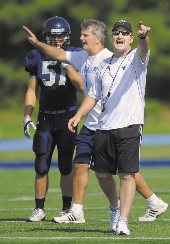 GLAD TO BE BACK: New University of Maine defensive coordinator Paul Ferraro, right, sought out the opportunity to join head coach Jack Cosgrove’s staff in the offseason. Ferraro was a coach at Maine in 1989 before coaching for serval teams in the NFL.