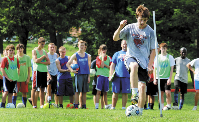 SETTING AN EXAMPLE: Messalonskee High School senior midfielder Jarrod Simpson demonstrates a dribbling drill during the first day of soccer practice in Oakland on Monday. The Eagles are the defending Eastern Maine Class A champs.