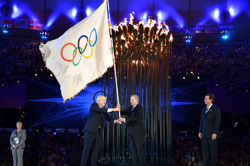 SYMBOLIC GESTURE: The Olympics flag is handed from London Mayor Boris Johnson, second from left, to International Olympic Committee President Jacques Rogge, as Rio de Janeiro Mayor Eduardo Paes watches during Sunday's closing ceremony of the 2012 Olympics in London. Diving