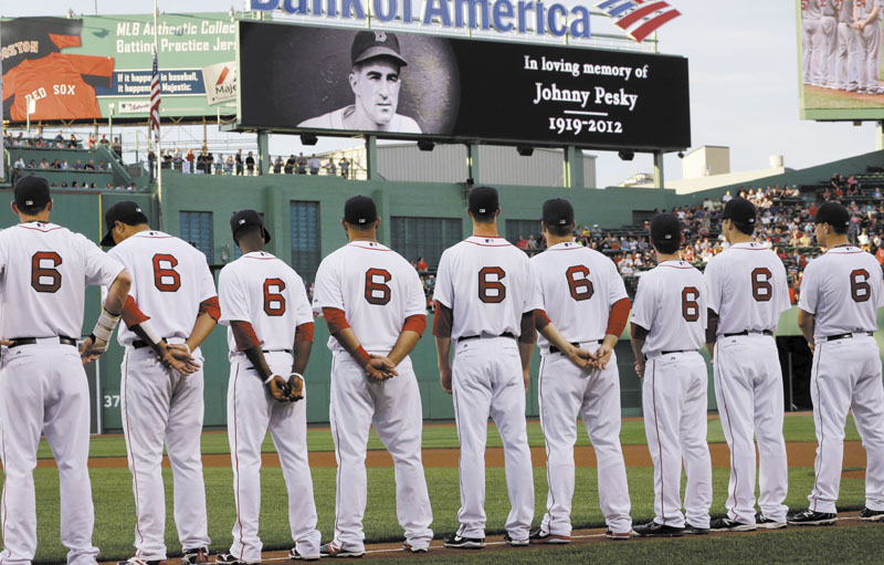 HONORING NO. 6: Boston Red Sox players, all wearing No. 6 jerseys, line up on the field at Fenway Park to honor the late Johnny Pesky, prior to the Sox game against the Los Angeles Angels on Tuesday in Boston.