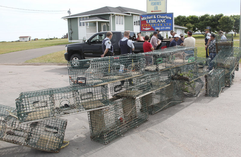 Fishermen in Cap-Pele, New Brunswick, blocked access to several processing plants Thursday to protest an influx of Maine lobster after being told they would be expected to provide fewer lobsters when their season opens next week.