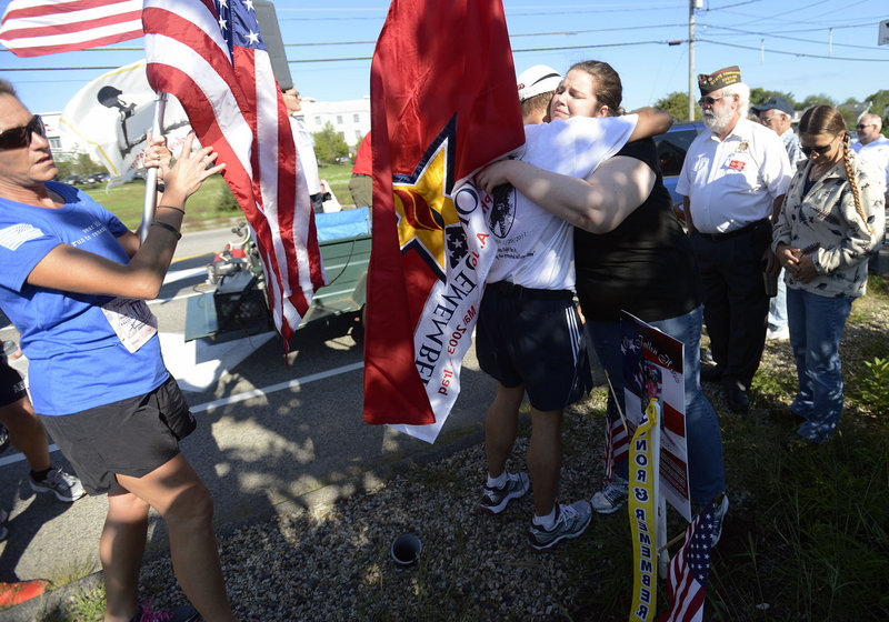 Runners stop to give Meghan Slack of Waterville a hug during the Run for the Fallen along the route in Wells on Sunday. Slack lost her brother Spc. Wade Slack of Waterville, who died while serving in the Army in Afghanistan in 2010.
