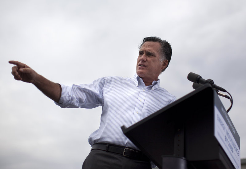 Former Massachusetts Gov. Mitt Romney speaks at a campaign rally Thursday in Hobbs, N.M. A bill he signed into law in 2006 sought to expand health care but did not guarantee coverage.