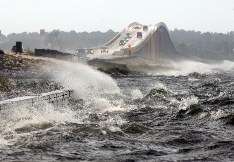 Waves from the Santa Rosa Sound crash over the Navarre Beach causeway Tuesday in Navarre, Fla. The hurricane didn’t appear to affect the Republican convention in Tampa.