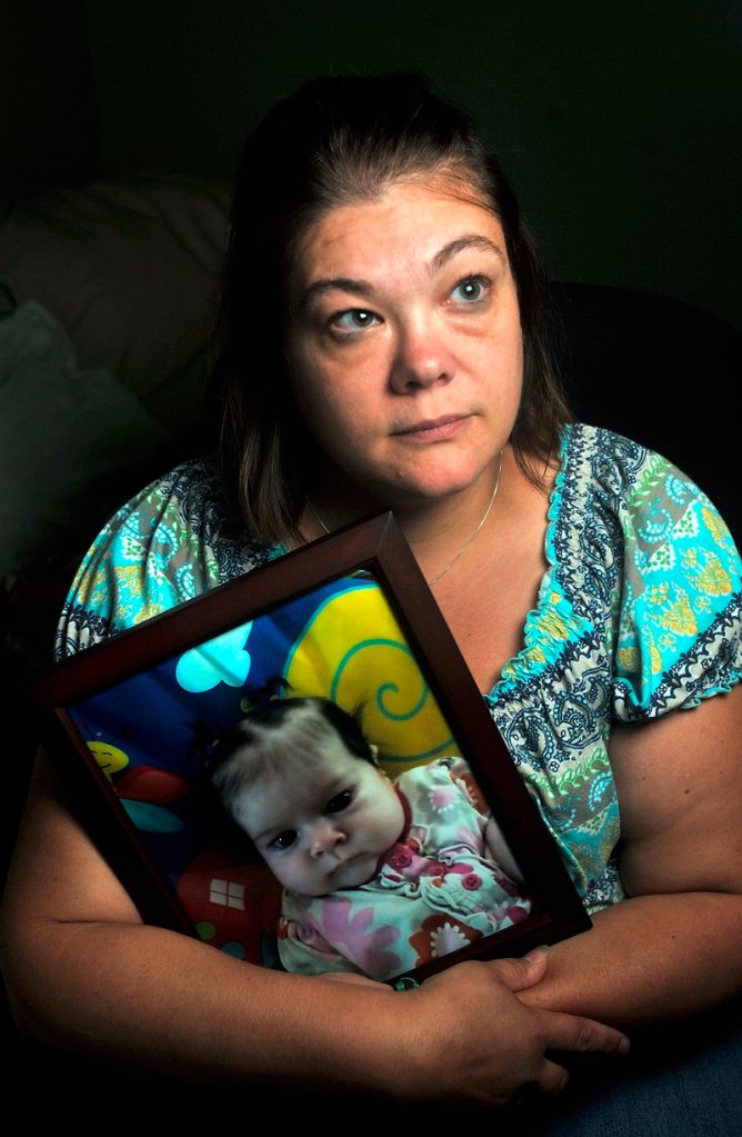 Nicole Greenaway holds a picture of her 3-month-old daughter, Brooklyn, who was killed.