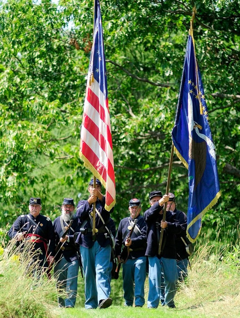 A group portraying soldiers from the 20th Maine walking into a clearing during a Civil War reenactment event on Saturday afternoon at Viles Arboretum in Augusta.