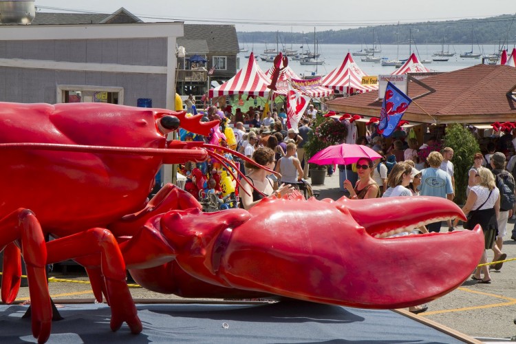 The crowd funnels into Rockland's Annual Lobster Festival, past a giant crustacean, during last year's fest. File photo