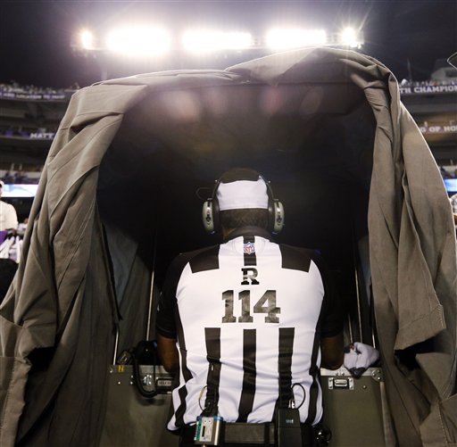 Referee Gene Steratore looks over the instant replay monitor before an NFL football game between the Baltimore Ravens and Cleveland Browns in Baltimore, Thursday, Sept. 27, 2012. (AP Photo/Patrick Semansky) NFLACTION12;