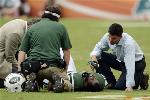 FILE - In this Sunday, Sept. 23, 2012 file photo, New York Jets trainers attend to cornerback Darrelle Revis (24) during the second half of an NFL football game against the Miami Dolphins, in Miami. Revis has a torn anterior cruciate ligament in his left knee that will require surgery, likely meaning he'll miss the rest of the season, the team announced Monday, Sept. 24. (AP Photo/Rhona Wise, File) Darrelle Revis