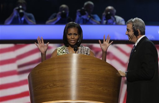 First Lady Michelle Obama appears at the podium for a camera test as head stage manager David Cove, right, instructs on the stage at the Democratic National Convention inside Time Warner Cable Arena in Charlotte, N.C., on Monday, Sept. 3, 2012. (AP Photo/Charles Dharapak)