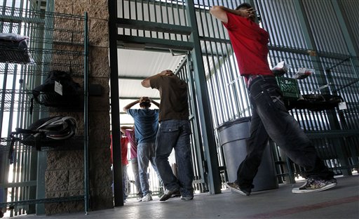 Illegal immigrants prepare to enter a bus after being processed at Tucson Sector U.S. Border Patrol Headquarters recently in Tucson, Ariz.