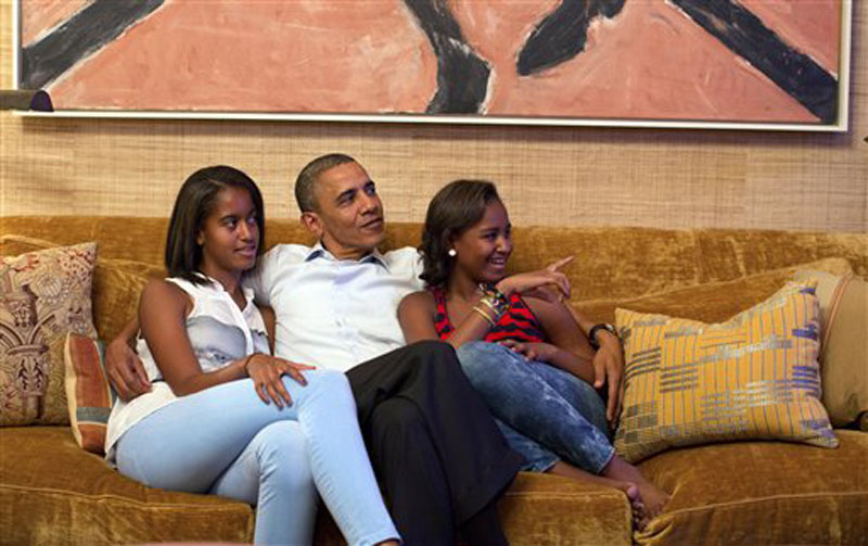 In this image released by the White House, President Barack Obama and his daughters, Malia, left, and Sasha, watch first lady Michelle Obama speak at the Democratic National Convention on television from the Treaty Room of the White House Tuesday, Sept. 4, 2012. (AP Photo/The White House, Pete Souza)