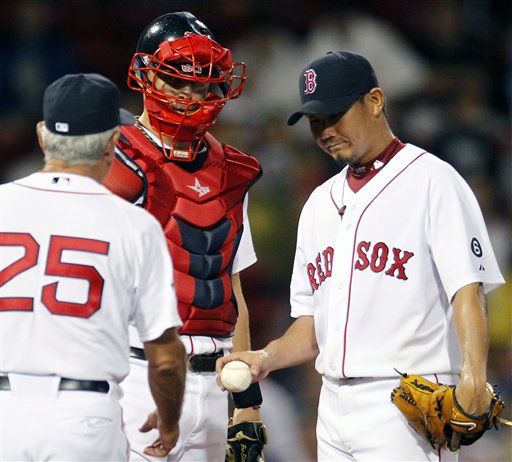 Boston Red Sox's Daisuke Matsuzaka, right, hands the ball to manager Bobby Valentine (25) as Ryan Lavarnway, left, looks on in the second inning of a baseball game against the Toronto Blue Jays in Boston, Saturday, Sept. 8, 2012. (AP Photo/Michael Dwyer)