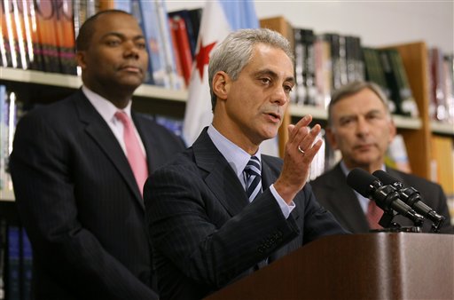 Chicago Mayor Rahm Emanuel, center, is flanked by Chicago Public Schools CEO Jean-Claud Brizard, left, and school board president David Vitale during a news conference after the teachers union House of Delegates voted to suspend their strike Tuesday in Chicago.