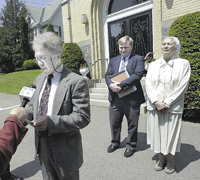 Jamie Morrill, then-assistant commissioner of the Department of Behavior and Development Services, speaks to the media outside the Blessed Sacrament Chapel in Waterville in this 2003 file photo regarding the decision to allow Mark Bechard supervised leaves from AMHI. At right iattorney David Bernier and Sister Mary Catherine Perko. morrill jamie morris john perko mary bernier david blessed sacrament bechard