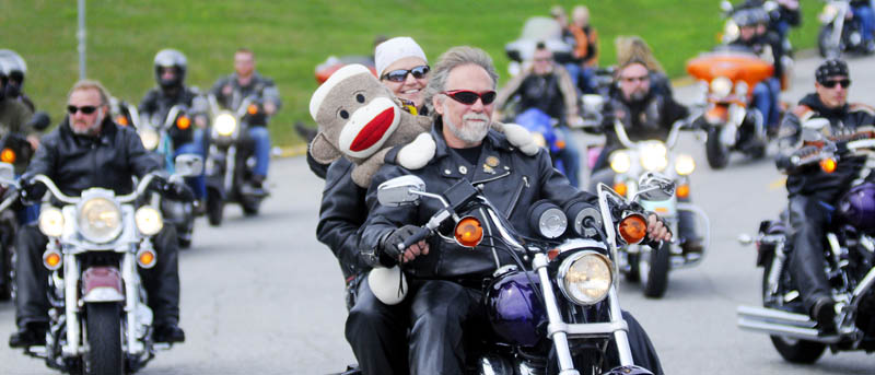 Motorcyclists roll out of the Augusta Civic Center at noon on Sunday at the commencement of the annual United Bikers of Maine Toy Run. Augusta police estimated a couple thousand bikes road from the ACC to the Windsor Fairgrounds to donate toys.