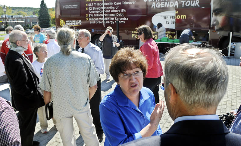 Staff photo by Andy Molloy TOUR: Maine State Director for Americans for Prosperity speaks with Maine State Treasurer Bruce Poliquin Monday during the conservative group's bus tour through Augusta.