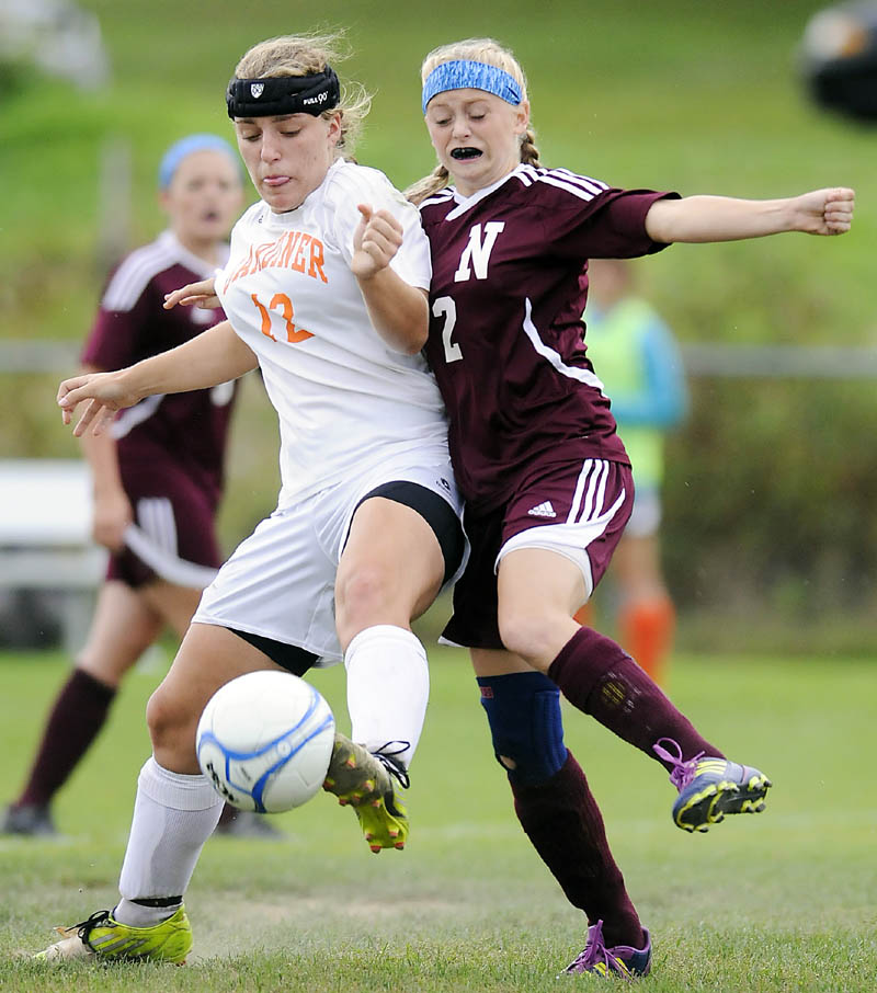 STEPPING UP: Gardiner Area High School’s Ally Day, left, tips the ball away from Nokomis High School’s Audrey Temple during the Tigers’ 4-2 win Tuesday in Gardiner.