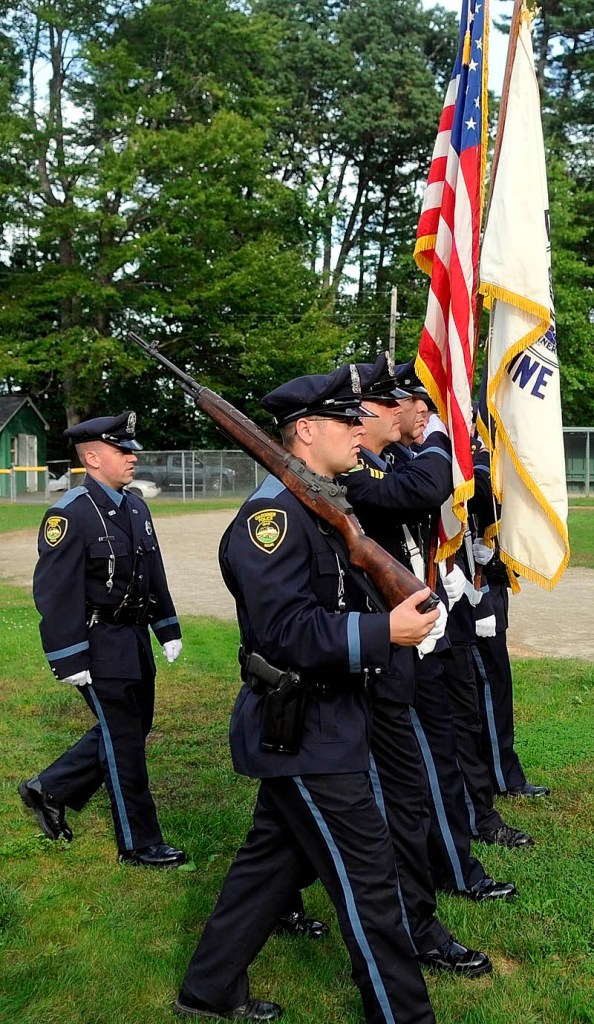 AN HONOR: Gardiner police officers rehearse a color guard presentation of flags Thursday in Gardiner. The police are carrying the colors tonight at Fenway Park in Boston.