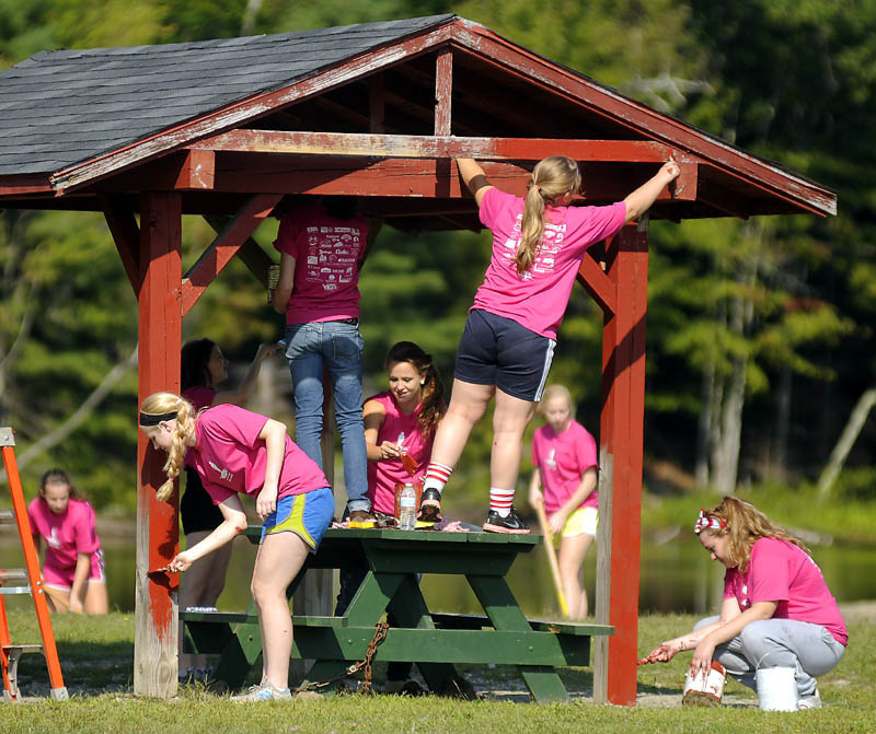 CARE: Hall-Dale High School students paint a picnic shelter Wednesday at the Hallowell recreation area during the school's first Day of Caring. About 100 students enrolled in the Jobs for Maine's Graduates program, Key Club and National Honor Society worked on projects across Hallowell during the school's first public service day, according to Lydia Leimbach, who coordinated the effort.