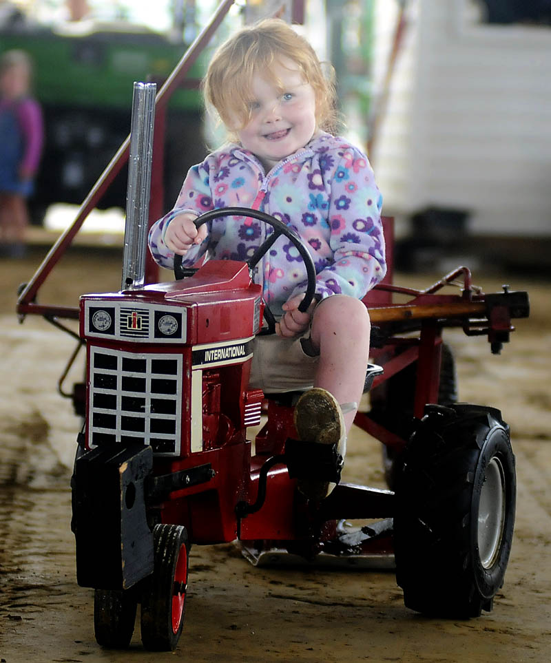 Elora Bogdanski, 3, of South Bristol, peddles to a first place finish Sunday in the 33 pound class of the Kiddie Tractor Pull at the Windsor Fair.