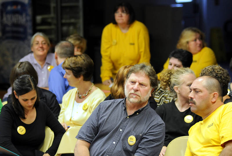 SOLIDARITY: Wearing yellow buttons and yellow t-shirts, teachers from throughout the Maranacook school system attended a school board meeting in Readfield on Wednesday to protest working without a contract for two years.