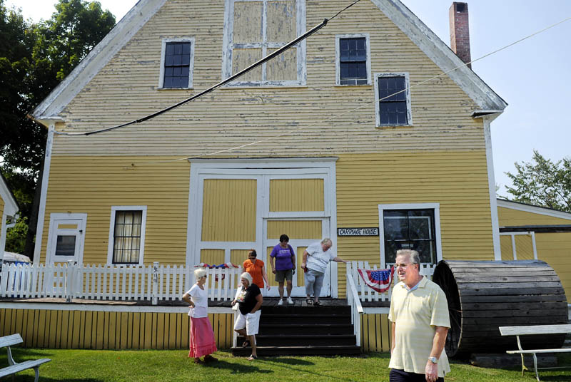 Visitors tour the carriage house Thursday at the Monmouth Museum on Main Street in Monmouth. A new book, "Recalling Monmouth's Greatest Turf and Farm Era," about the agricultural history of the community is raising funds for the care of the Museum.