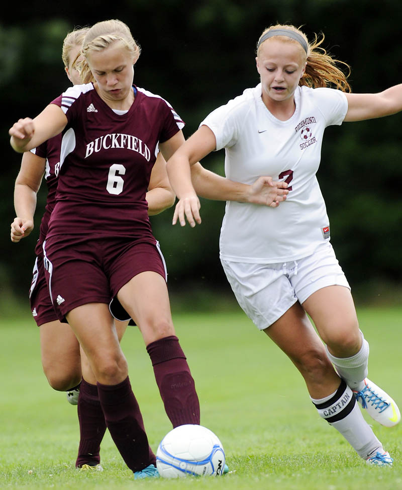 Richmond High School’s Noell Acord, right, battles for the ball with Buckfield High School’s Elizabeth Strout, left, and Dakota Warren during a soccer game Wednesday in Richmond. The Bobcats won 4-0. For local roundup, see C3.