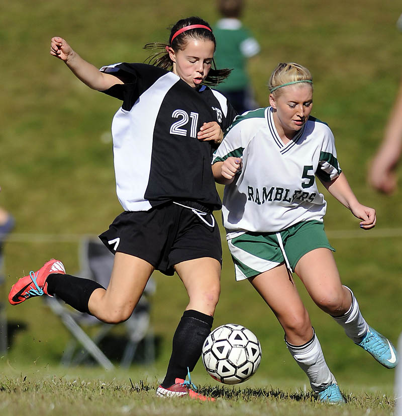 Hall-Dale High School’s Signe Lynch, left, tries to get a shot off past Winthrop High School’s Annie Guerette during a game Monday in Winthrop. The Bulldogs won 5-1. For local roundup, see C3.