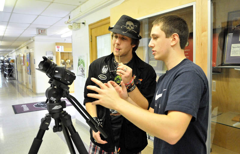 Staff photo by Michael G. Seamans Messalonskee High School seniors, Eric Mathews, left, and Dustin Wood, right, work out camera agnles as they shoot a 35 second video during Mass Media Communication's class at Mid-Maine Technical Center at waterville Senior High School Thursday.