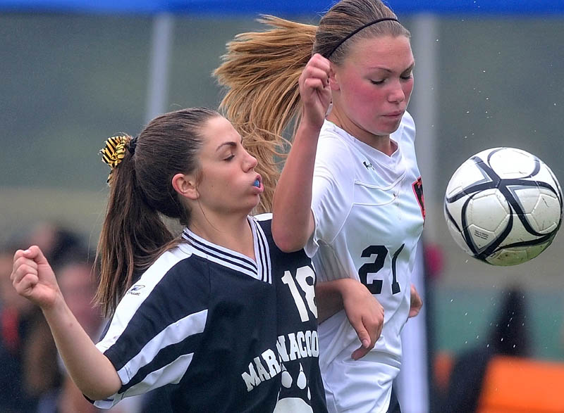 Staff photo by Michael G. Seamans Maranacook Community High School's Sarah Clough, 18, left, battles with Winslow High School's Kamryn Michaud, 21, right for the ball in the second half of soccer action in Winslow Saturday.