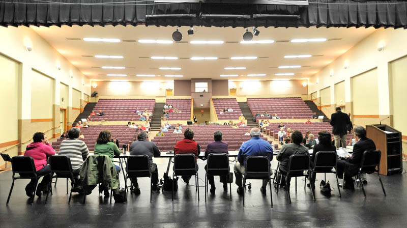 Staff photo by Michael G. Seamans Members of the RSU 18 school board sit on the stage as the RSU 18 district budget meeting is brought to order at Messalonskee High School Thursday.