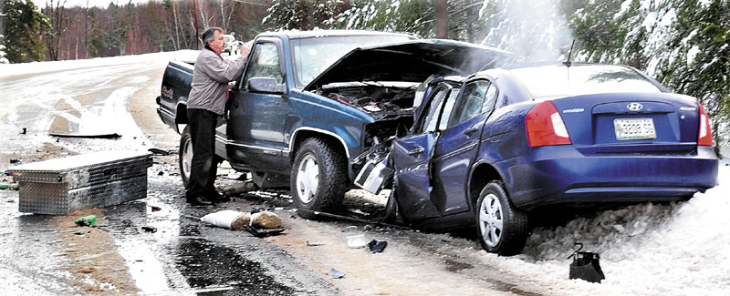 Frank Keithan of Troy speaks with two injured occupants of a pickup truck Jan. 19, 2011, after a head-on collision with a Hyundai that killed the woman driving the sedan. The crash happened on a slush-covered stretch of Route 139 in Unity Township.