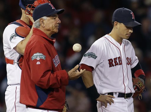 Boston Red Sox manager Bobby Valentine tosses a baseball while he and shortstop Jose Iglesias, right, and catcher Ryan Lavarnway, partially hidden, wait on the mound for relief pitcher Andrew Miller in the eighth inning against the Tampa Bay Rays at Fenway Park in Boston, Tuesday, Sept. 25, 2012. The Rays won 5-2. (AP Photo/Elise Amendola)