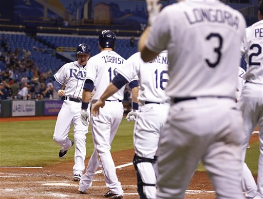 Tampa Bay Rays Elliot Johnson scores a run in the bottom of the ninth inning against the Boston Red Sox of a baseball game, Thursday, Sept. 20, 2012, in St. Petersburg, Fla. (AP Photo/Scott Iskowitz)