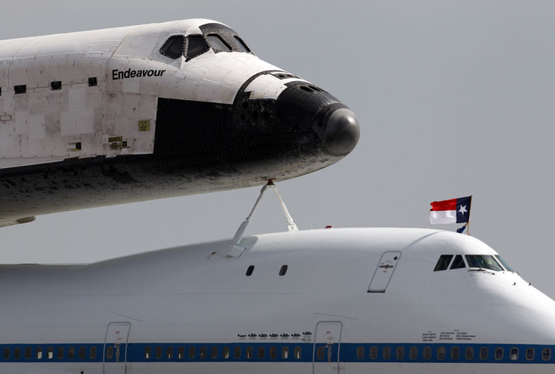 A Texas flag inadvertently flies upside down as NASA's 747 Shuttle Carrier Aircraft taxis the Space Shuttle Endeavour into position at Ellington Field in Houston on Wednesday morning September 19, 2012. Endeavour will spend the night in Houston before continuing its journey from the Kennedy Space Center in Florida to the California Science Center in Los Angeles where it will be on permanent display.