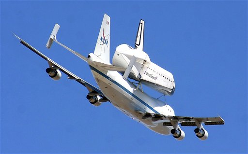 The retired shuttle Endeavour piggy-backs a modified Boeing 747 Shuttle Aircraft Carrier Thursday over White Sands Missile Range east of Las Cruces, N.M.