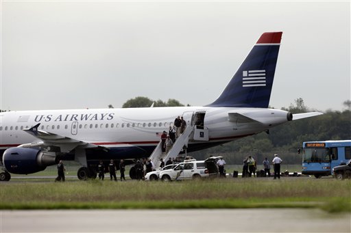 Passengers walk off a US Airways flight at Philadelphia International Airport on Thursday. An airline spokeswoman says Flight 1267 returned to the airport as a "precaution."