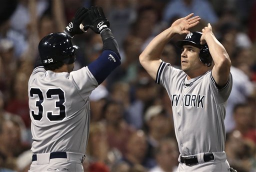 New York Yankees' Steve Pearce, right, is congratulated by Nick Swisher after scoring on a single by Derek Jeter in the seventh inning against the Boston Red Sox in a baseball game, Thursday, Sept. 13, 2012, at Fenway Park in Boston. (AP Photo/Charles Krupa)