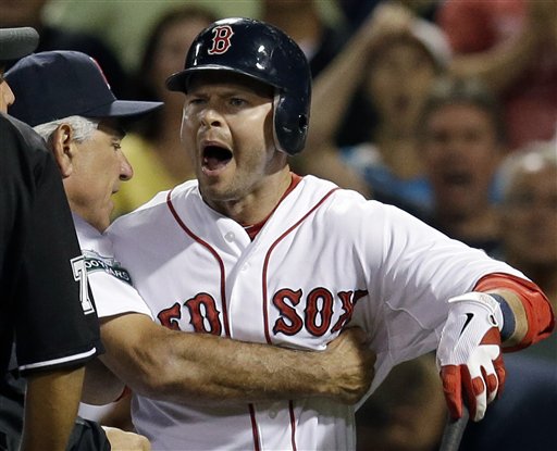 Boston Red Sox's Cody Ross, right, is held back by manager Bobby Valentine as he argues with home plate umpire Alfonso Marquez over his called third strike in the eighth inning of a baseball game against the New York Yankees at Fenway Park in Boston Wednesday, Sept. 12, 2012. The Yankees won 5-4. (AP Photo/Elise Amendola)