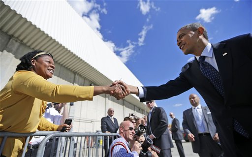 President Barack Obama reaches over to greet a supporters on the tarmac upon his arrival on Air Force One, Monday, Sept. 24, 2012, at JFK airport in New York. (AP Photo/Pablo Martinez Monsivais)