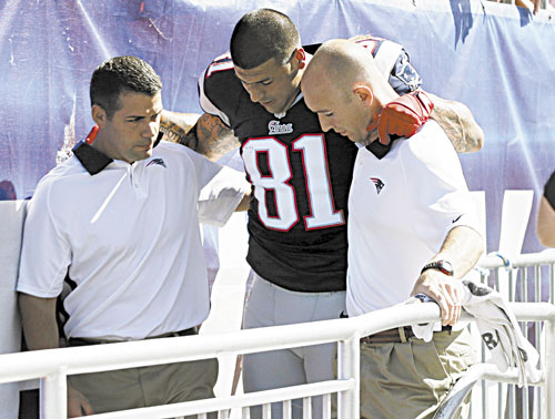 BAD BREAK: New England Patriots tight end Aaron Hernandez is helped from the field with an ankle injury in the first quarter against the Arizona Cardinals on Sunday in Foxborough, Mass. ESPN2 reported Hernandez will not play Sunday night against Baltimore.