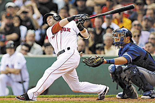 BRIGHT SPOT: Boston’s Dustin Pedroia follows through on his home run against the Toronto Blue Jays during the sixth inning Sunday at Fenway Park in Boston.