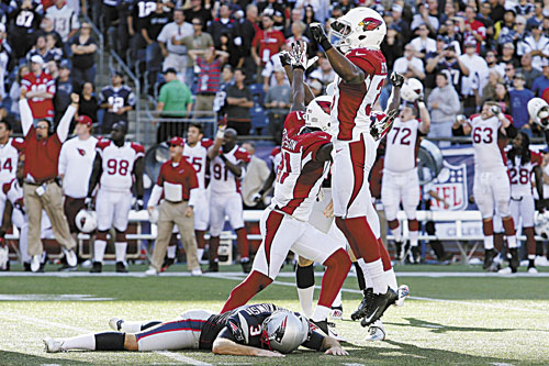 WIDE LEFT: Arizona Cardinals cornerback Justin Bethel, right, and teammates celebrate after New England Patriots kicker Stephen Gostkowski, bottom, missed a field at the end of the fourth quarter Sunday in Foxborough, Mass. The Cardinals won 20-18.