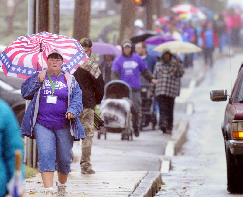 Sandy Folsom, left, was one of the about 200 people walking down Western Avenue during the Alzheimer's Association Walk to End Alzheimer's on Saturday morning in Augusta. They walked a 2.8 mile course that started at Buker Center headed down Western Avenue, over to and around Capital Park and back up the Capital Street to the starting point.