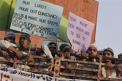 Supporters of a Pakistani religious group wear headbands that read, "at your service God's Prophet," as they listen to a speech by their leader, no pictured, during a demonstration that is part of widespread anger across the Muslim world about a film ridiculing Islam's Prophet Muhammad, in Lahore, Pakistan, Sunday, Sept. 23, 2012. (AP Photo/K.M. Chaudary)