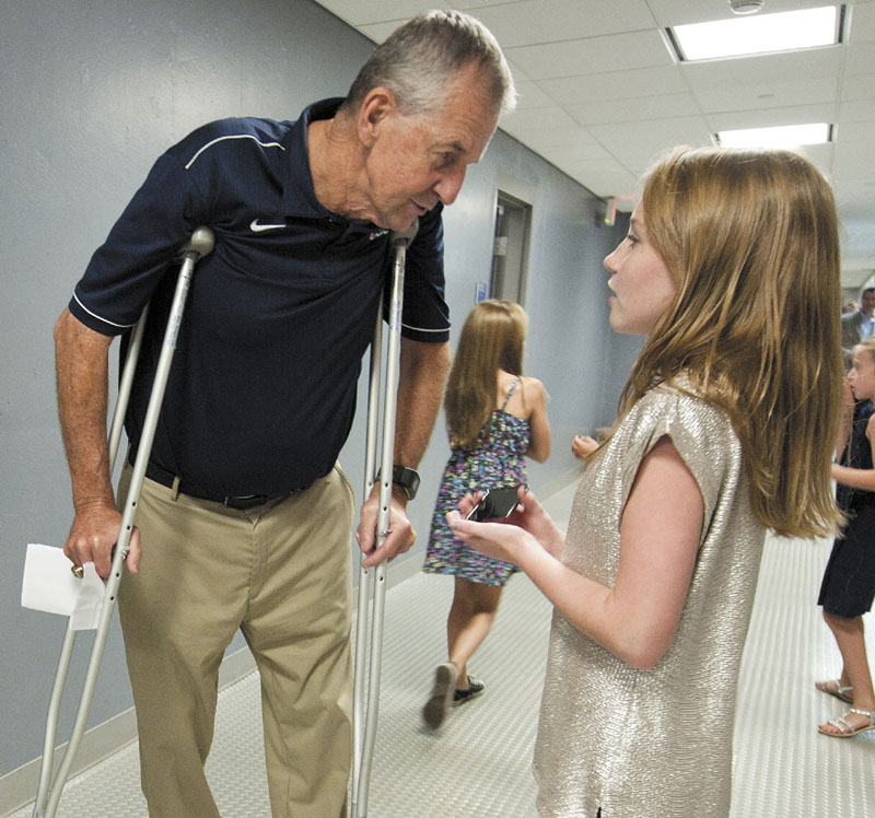 GRANDPA’S BIG NEWS: Jim Calhoun, left, talks with his granddaughter Emily Calhoun after announcing his retirement as the head men’s basketball coach at UConn on Thursday. Calhoun won three national titles at UConn.