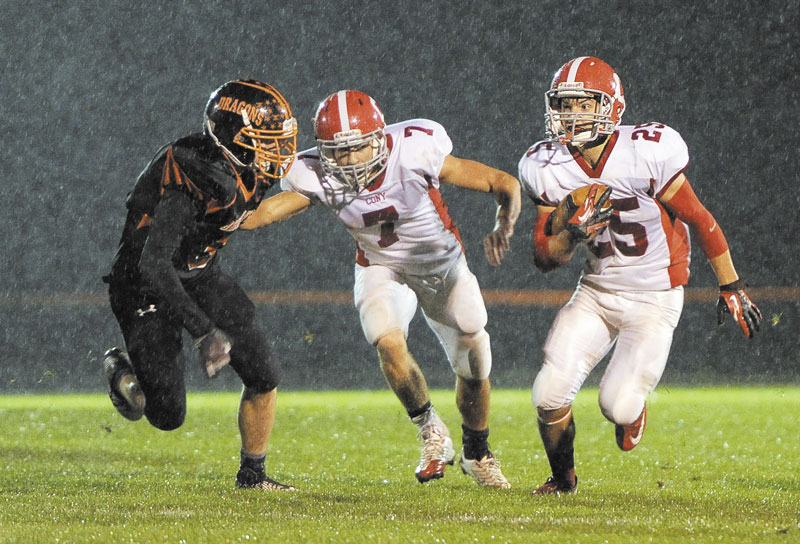 COMING THROUGH: Cony High School’s Tayler Carrier carries the ball while getting a block from teammate Chandler Shostak during the Rams’ 34-7 win over Brunswick on Friday in Brunswick.